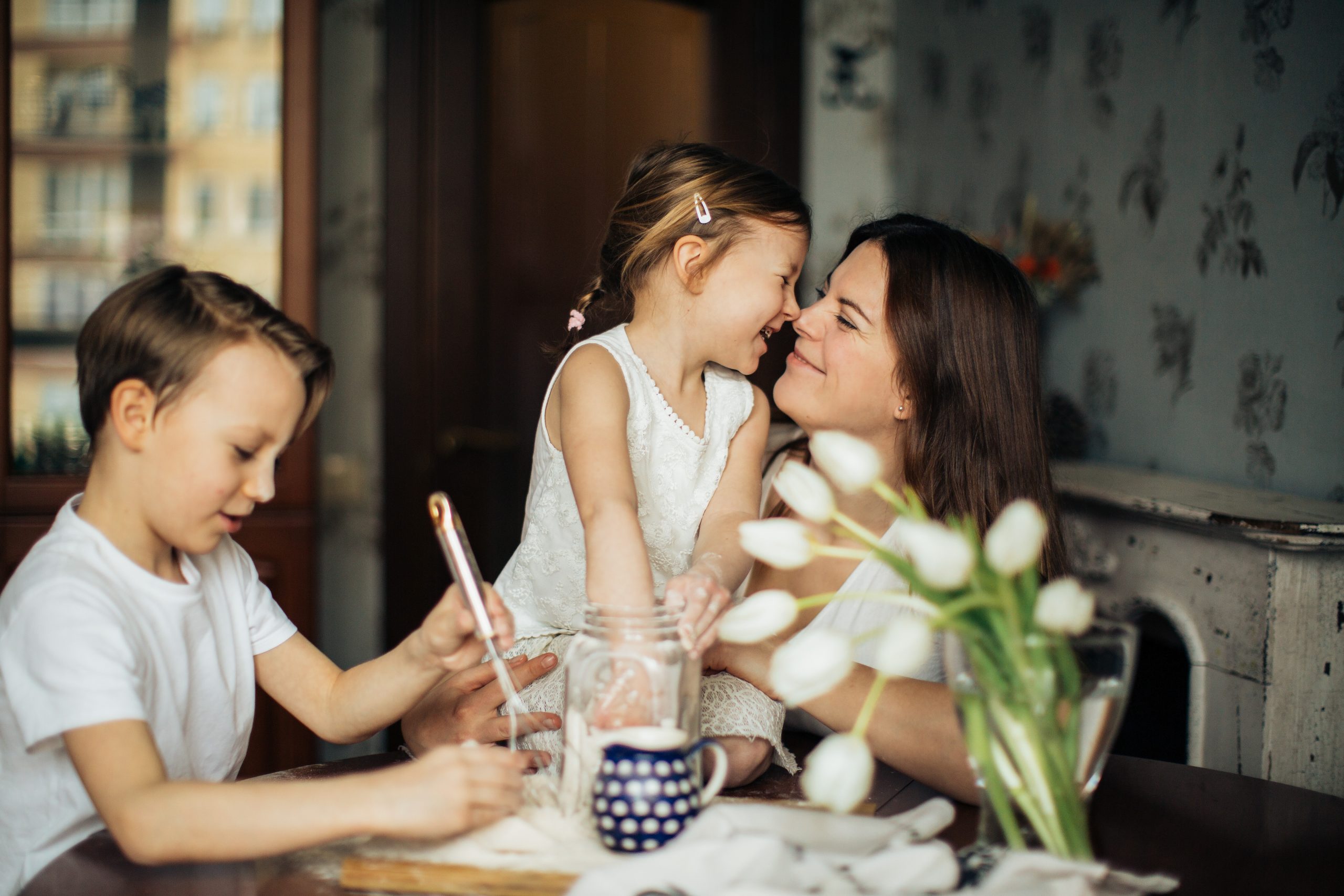 Smiling mother with two children at table