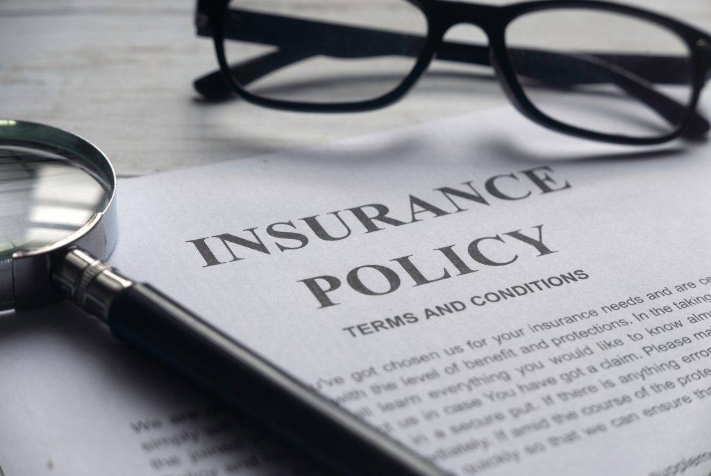 insurance policy papers with glasses