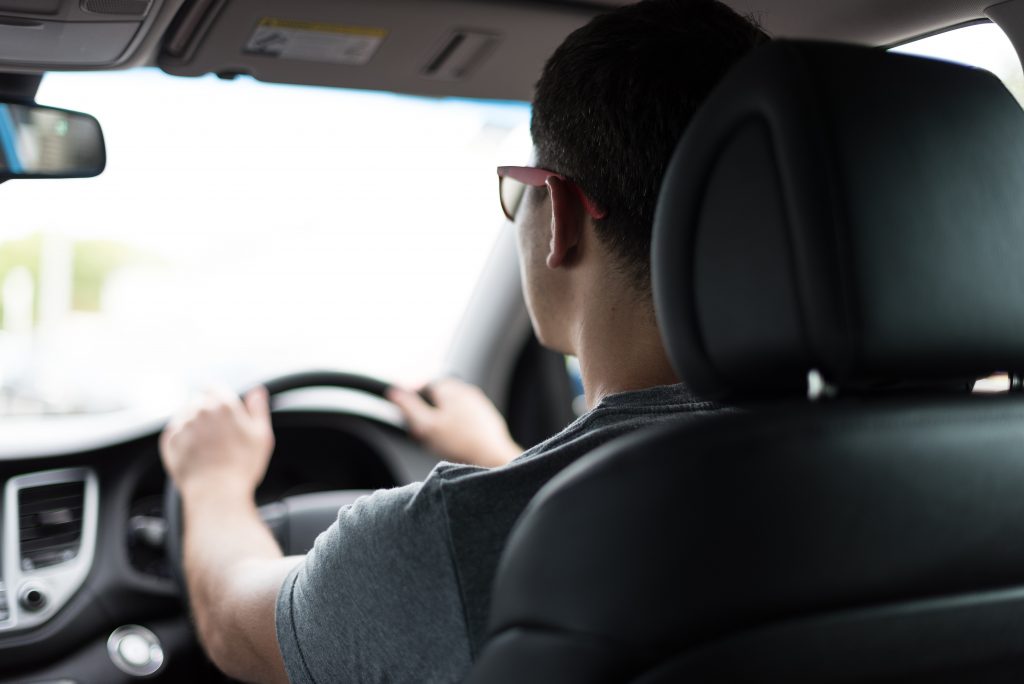 man driving in his car